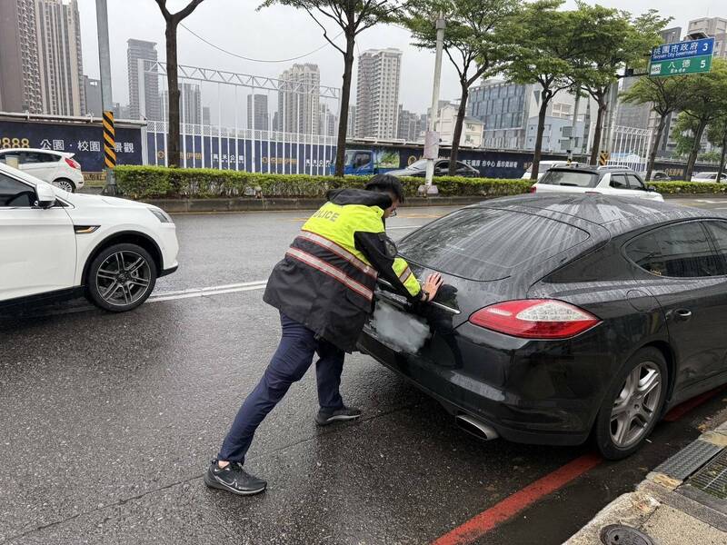 黑色保时捷雨天在南桃园交流道大兴西路往桃园方向抛锚,员警巡逻经过帮忙推车解围,过程中有热心货车司机加入,让后方回堵的车流赶紧纾解。(记者郑淑婷翻摄) 黑色保时捷雨天在南桃园交流道大兴西路往桃园方向抛锚,员警巡逻经过帮忙推车解围,过程中有热心货车司机加入,让后方回堵的车流赶紧纾解。(记者郑淑婷翻摄)